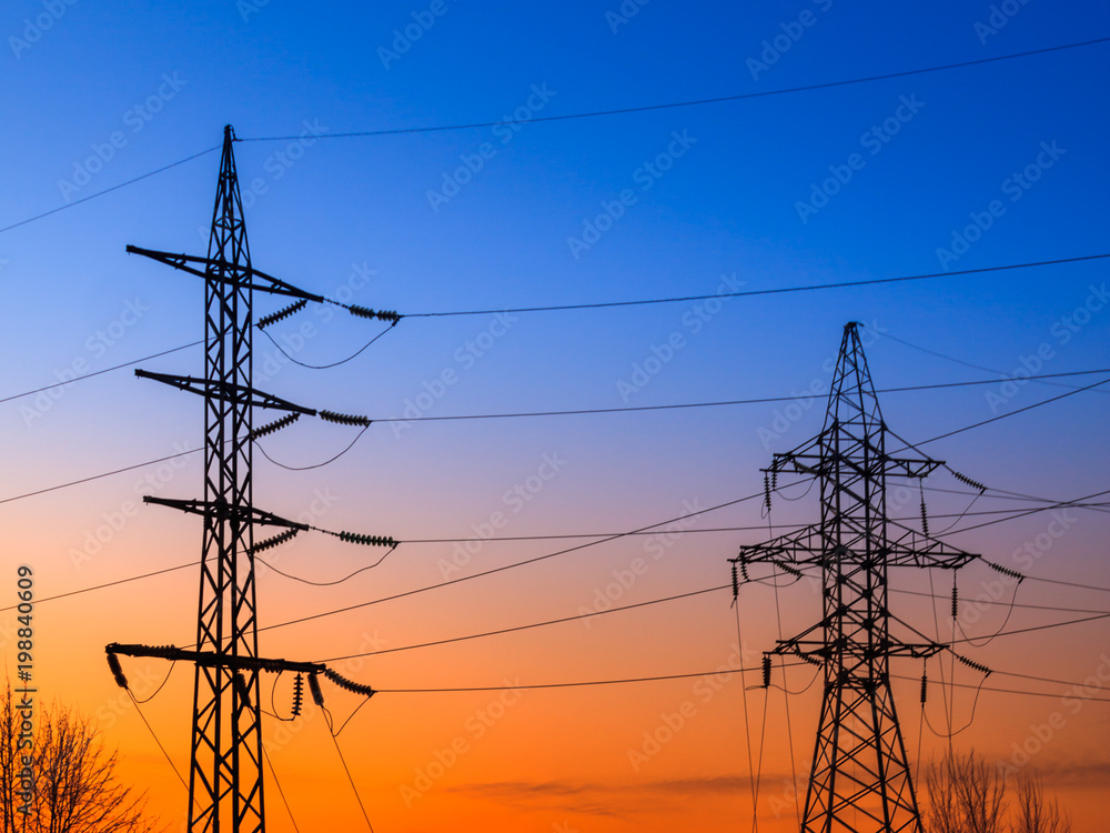 Image of high voltage power line and sky. High-voltage power lines at sunset. Electric transmission towers.