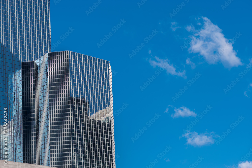 Clouds reflected in the many mirrored facets of a modern office building. Clouds reflected in the many mirrored facets of a modern office building.