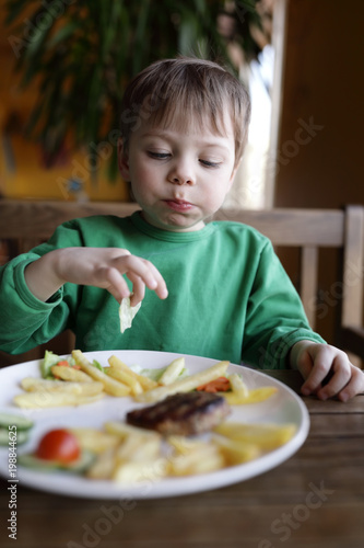 Child eating french fries