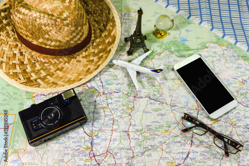 Travel Concepts Planning a trip with a camera. Model aircraft A small glass globe and a hat are placed on the map.