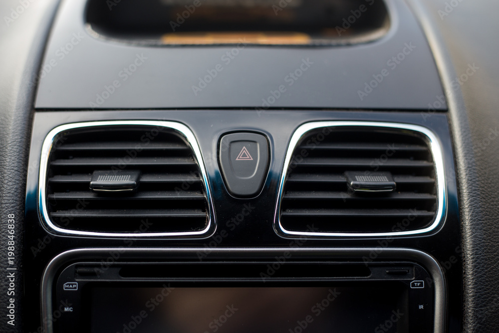 Car conditioner. The air flow inside the car. Detail interior. Air ducts, deflectors on the car panel