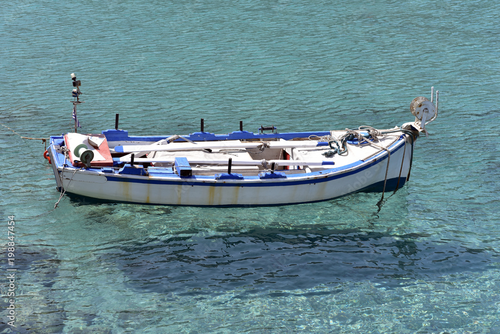 Fototapeta premium Traditional fishing boat in the sea near Adamantas village, Milos island, Greece