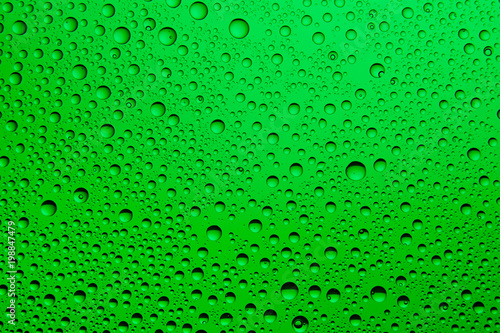 Green water drops on glass. Background.