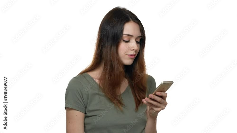 Portrait of caucasian woman 20s wearing casual clothes holding smartphone and browsing internet or social networking, isolated over white background. Concept of emotions Portrait of caucasian woman 20s wearing casual clothes holding smartphone and browsing internet or social networking, isolated over white background. Concept of emotions