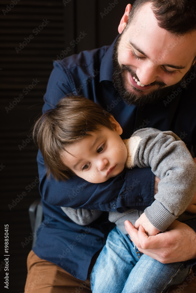 Small kid and his father at black Small kid and his father at black