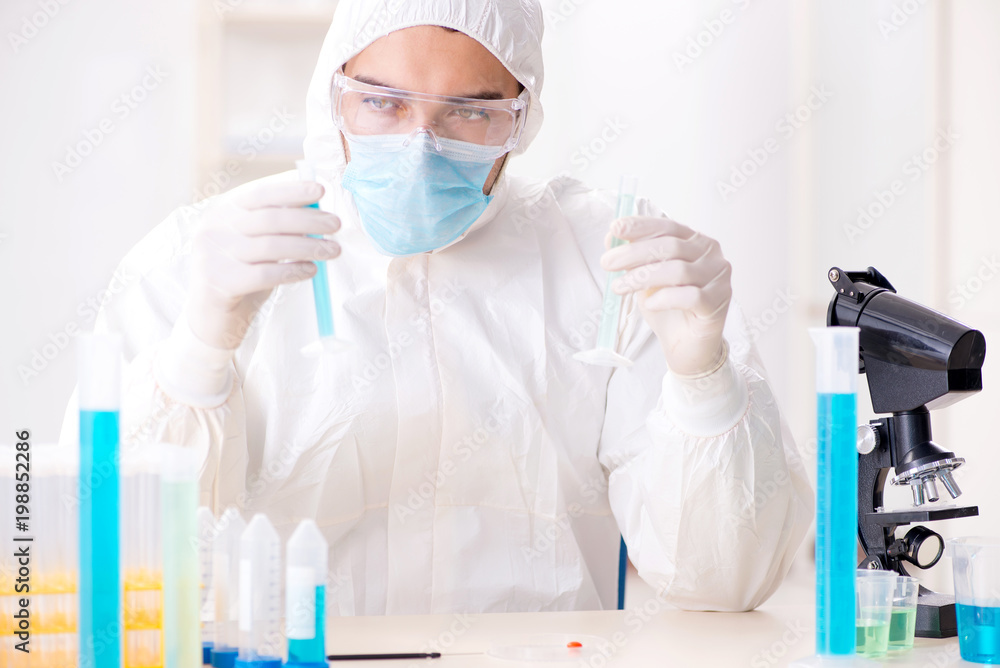Young chemist student working in lab on chemicals Young chemist student working in lab on chemicals