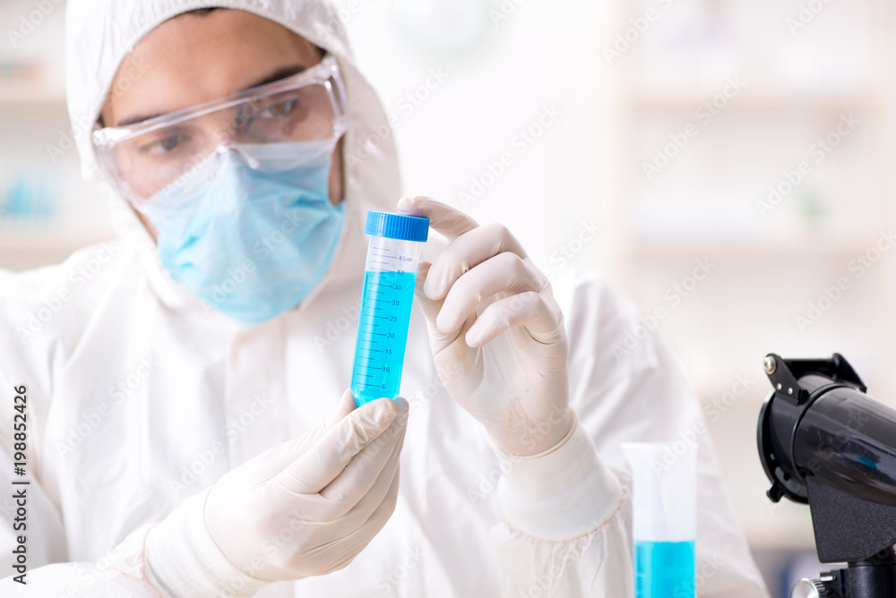 Young chemist student working in lab on chemicals Young chemist student working in lab on chemicals