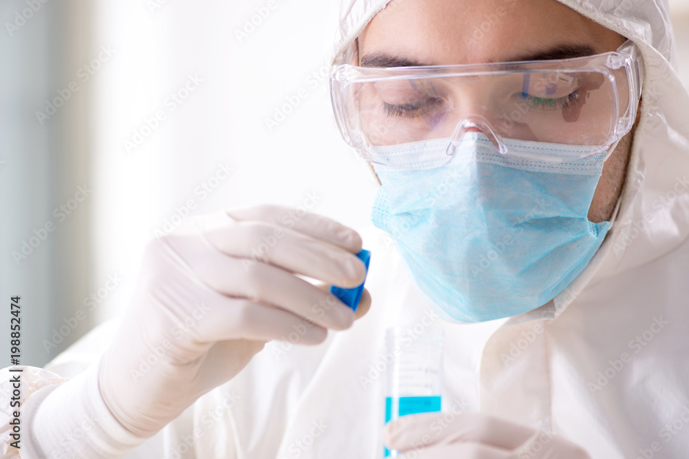 Young chemist student working in lab on chemicals Young chemist student working in lab on chemicals
