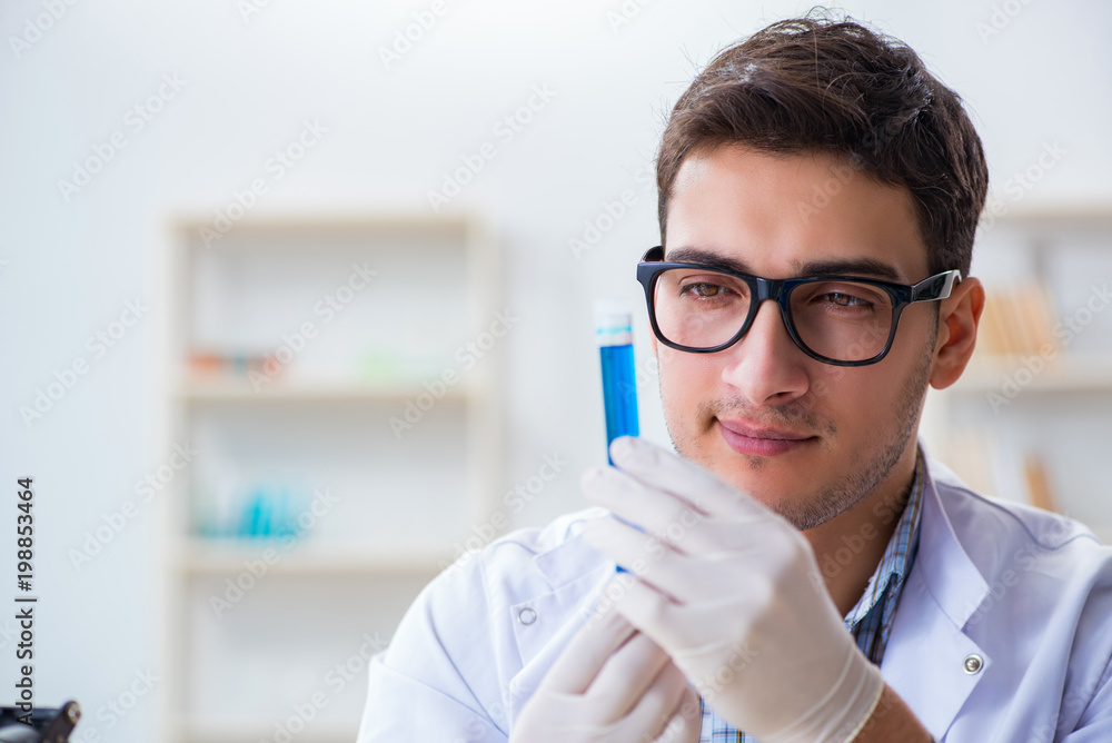 Young chemist student working in lab on chemicals Young chemist student working in lab on chemicals
