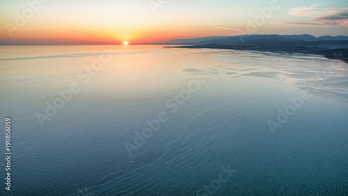 View from a height on a bright sunset over the sea.