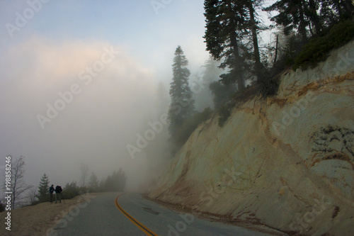 In the clouds on top of the mountain. The Sierra Nevada is a mountain range in the Western United States. photo