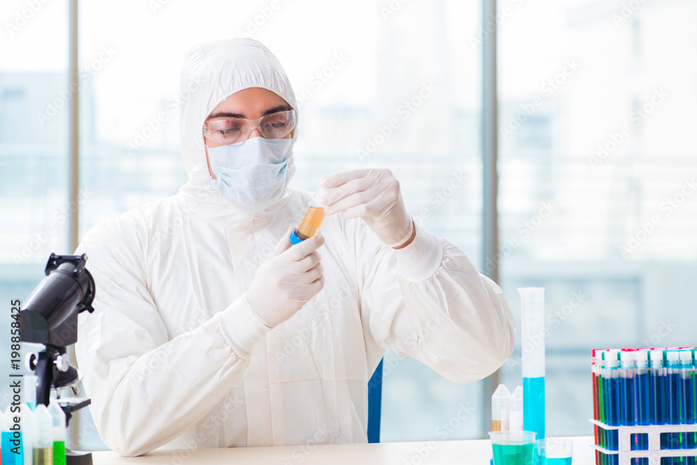 Young chemist student working in lab on chemicals Young chemist student working in lab on chemicals