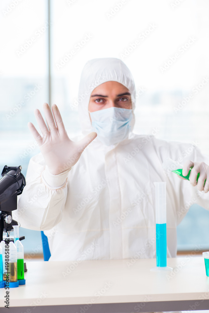 Young chemist pressing virtual buttons in lab Young chemist pressing virtual buttons in lab