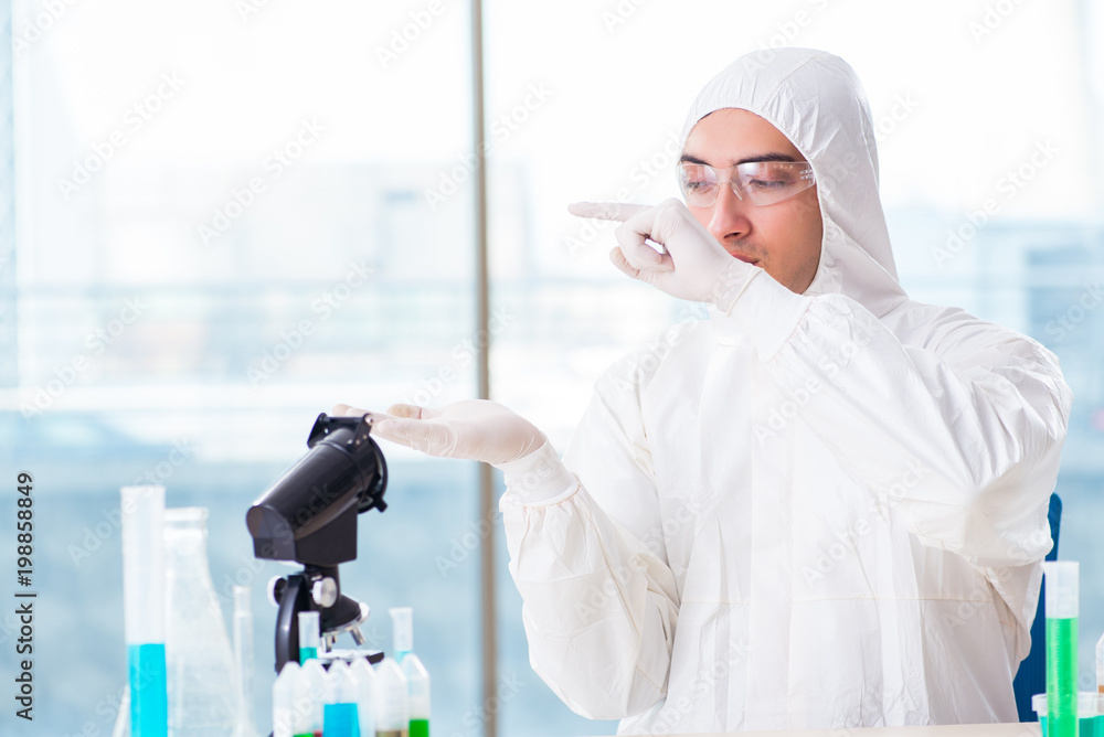 Young chemist student working in lab on chemicals Young chemist student working in lab on chemicals