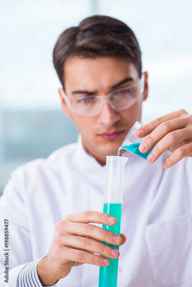 Young chemist student working in lab on chemicals Young chemist student working in lab on chemicals