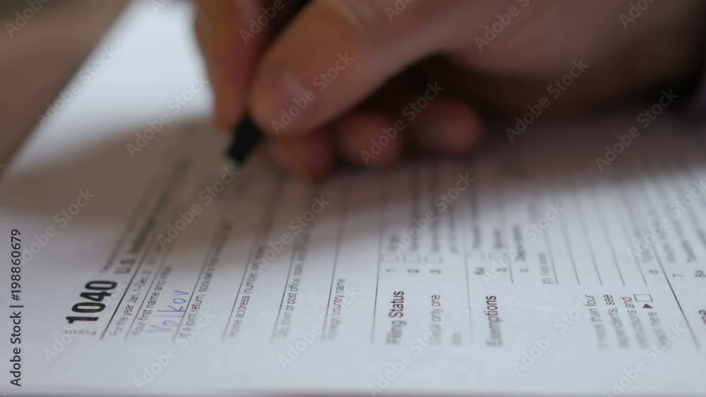 Man filling US tax form. tax form us business income office hand fill concept. Closeup. Man Is Checking The Box Of Filing Status In The US Individual Income. Tax Return Form 1040 Man filling US tax form. tax form us business income office hand fill concept. Closeup. Man Is Checking The Box Of Filing Status In The US Individual Income. Tax Return Form 1040