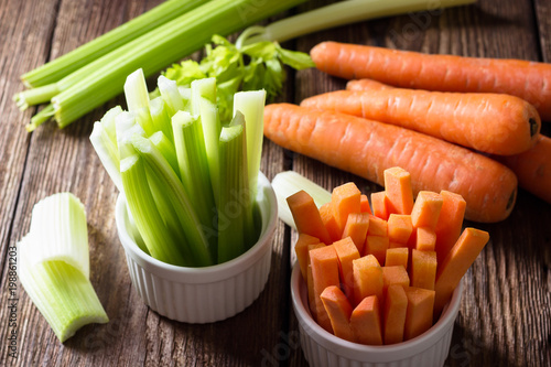 The sticks of carrots and celery on wooden table. photo