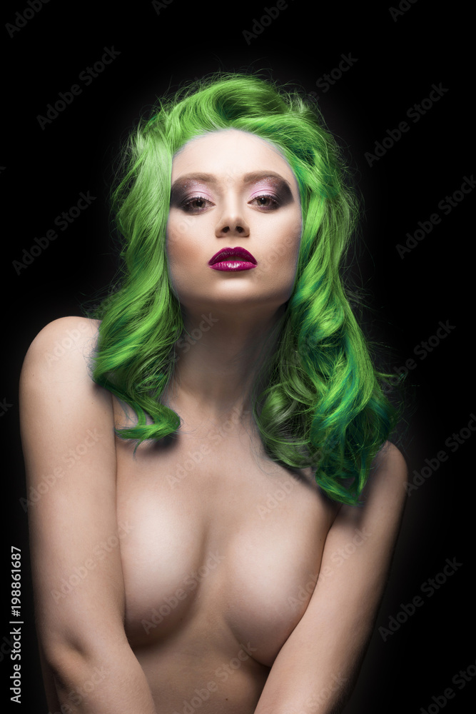 Foto de Sensual portain of beautiful dyed green colour hair topless  covering her big breast girl isolated on black background do Stock