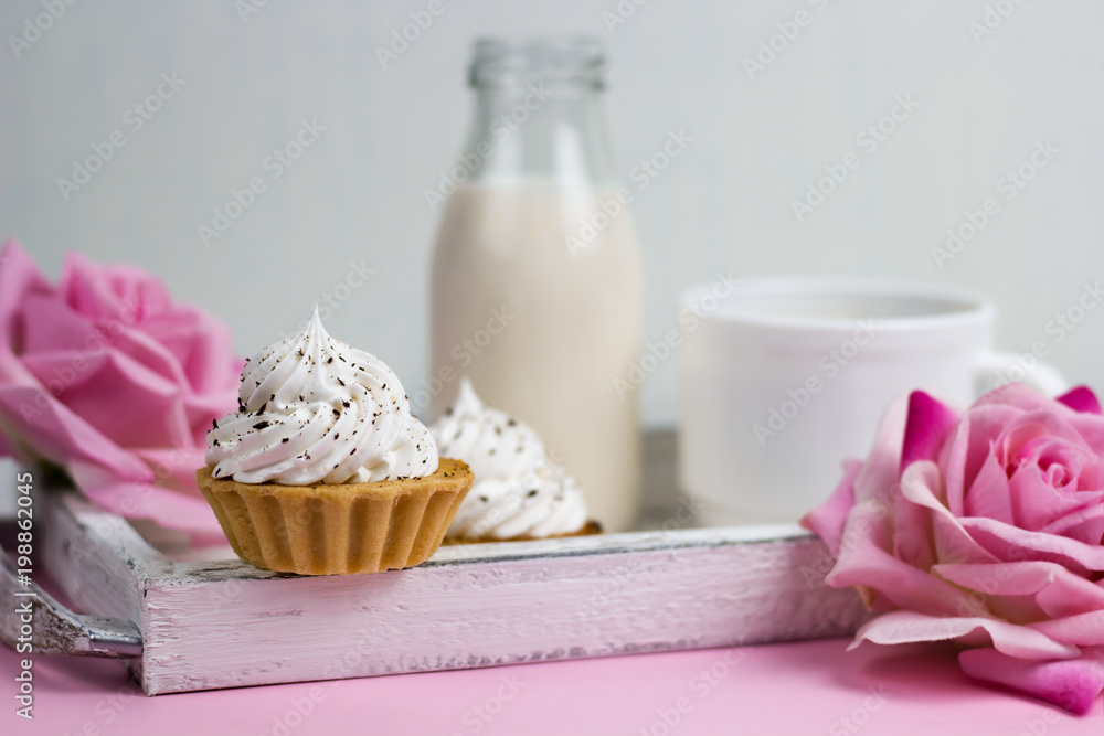 cupcake on a wooden tray with rose flowers, milk bottle and coffee cup, romantic breakfast on a vintage wooden tray cupcake on a wooden tray with rose flowers, milk bottle and coffee cup, romantic breakfast on a vintage wooden tray
