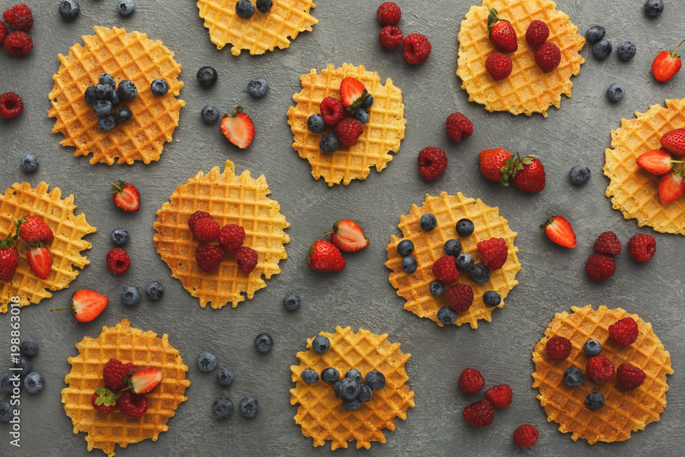 Round belgium waffles with berries top view Round belgium waffles with berries top view