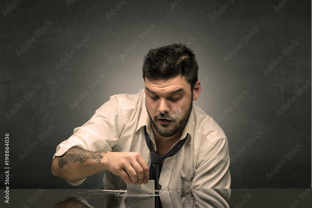 Young drunk man at his office with free dark copyspace Young drunk man at his office with free dark copyspace