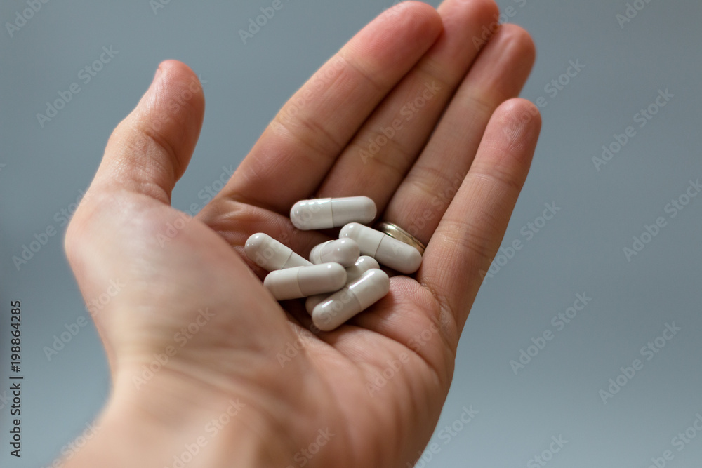 Close up shot of a hand full of pills Close up shot of a hand full of pills