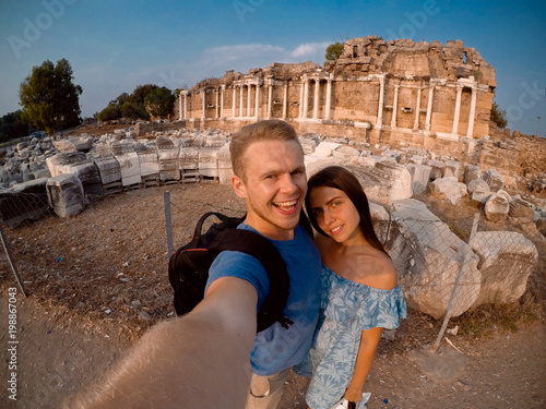 Photography Couple of tourists making selfie on camera in background of Greek ruins in Turkey, Greece