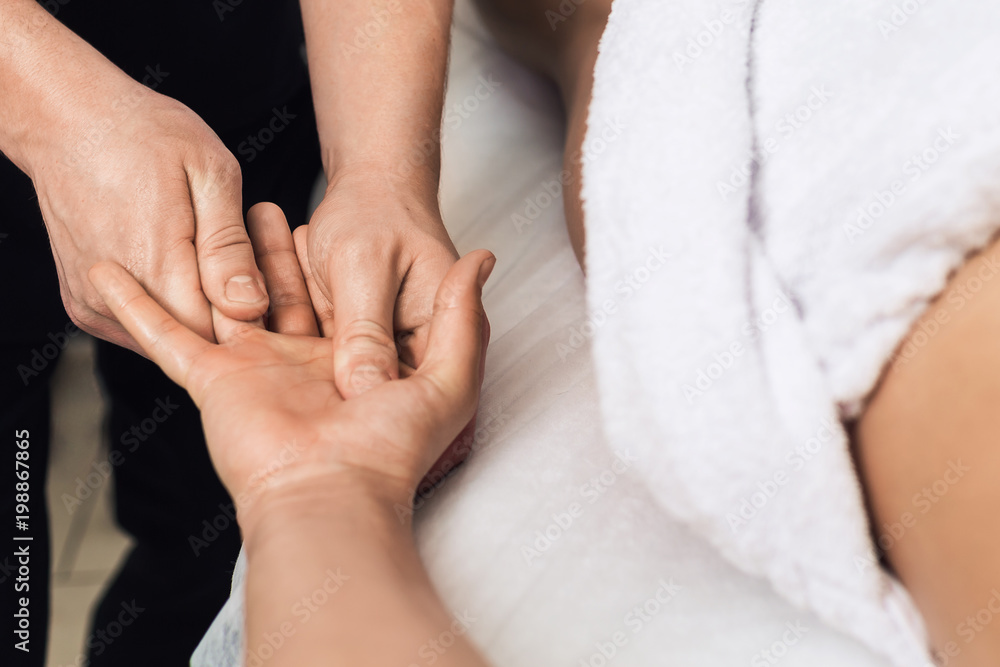 man does massage of palms and fingers in spa. Concept of healthy lifestyle. man does massage of palms and fingers in spa. Concept of healthy lifestyle.