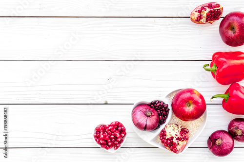 Fototapeta Naklejka Na Ścianę i Meble -  Diet for healthy heart. Food with antioxidants. Vegetables, fruits, nuts in heart shaped bowl on white wooden background top view copy space