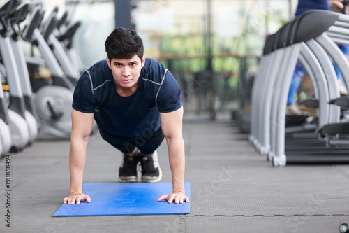 Asian man exercising in the gym, fitness, health, body good. © Somkiat
