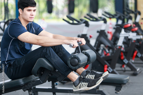 Asian man exercising in the gym, fitness, health, body good. © Somkiat