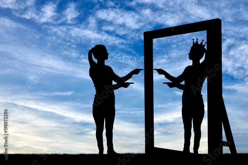 A silhouette of a narcissistic woman raises her self-esteem in front of a mirror photo