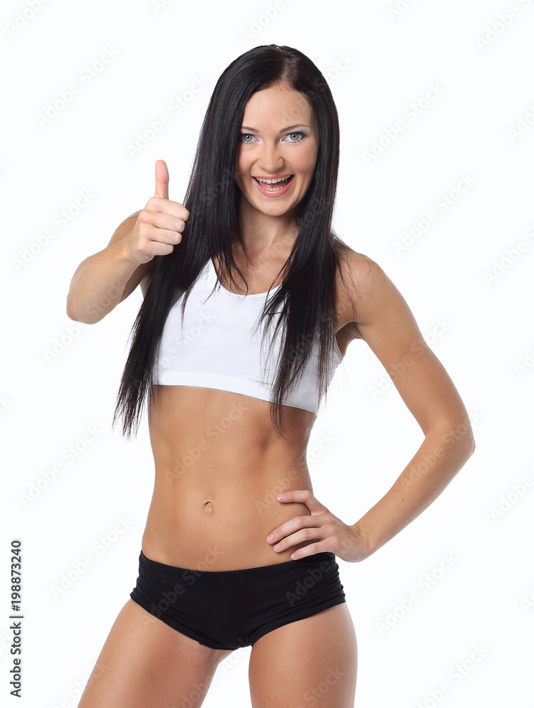 Fitness woman showing thumbs up success sign Fitness woman showing thumbs up success sign