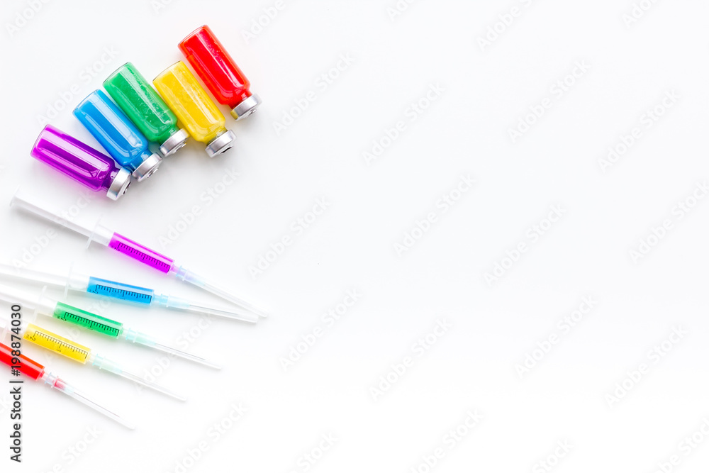 Syringe with colored drug. Injection concept on white background top view copy space Syringe with colored drug. Injection concept on white background top view copy space