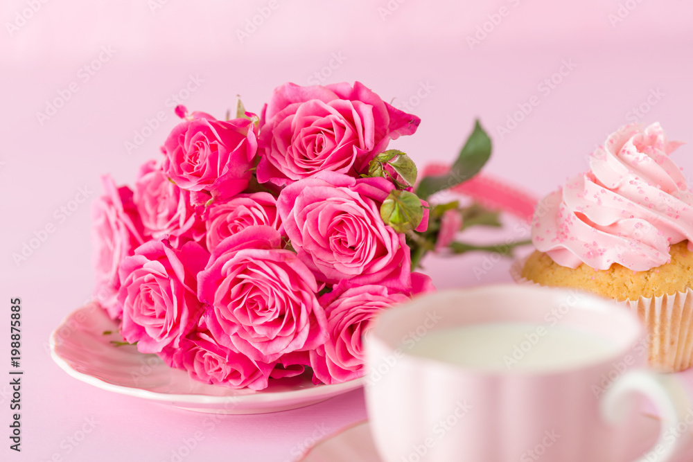 Cupcake with pink cream decoration and roses on pink pastel background. Cupcake with pink cream decoration and roses on pink pastel background.