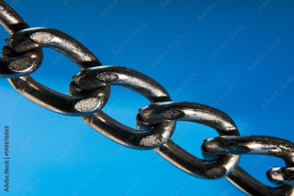 Obraz premium Metal chain close-up on a blue background