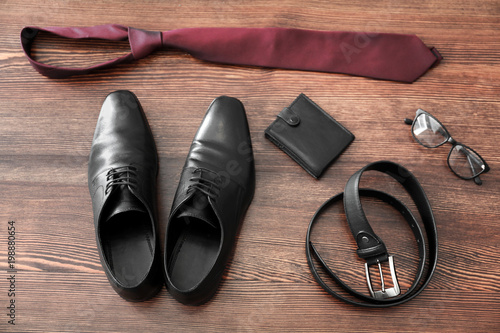 Composition with stylish men's shoes on wooden background