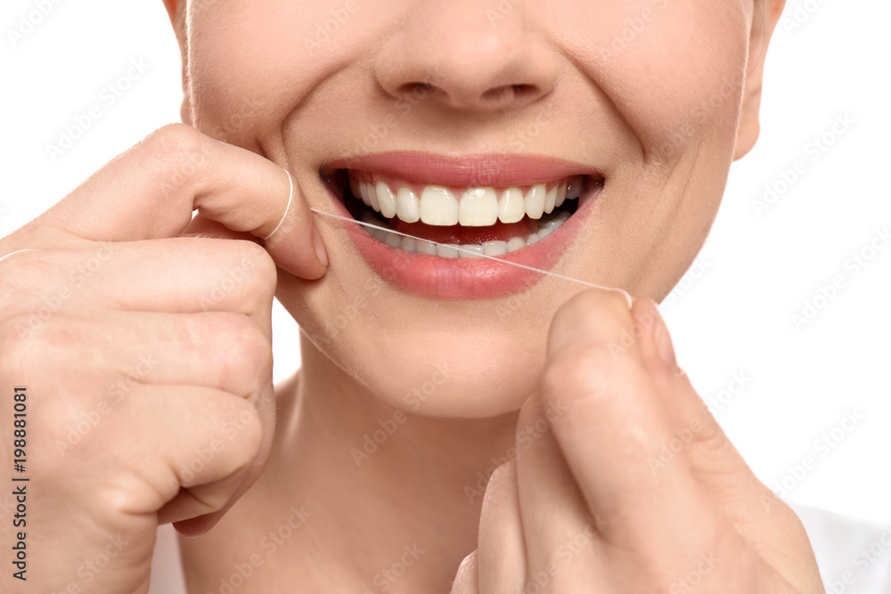 Young woman flossing her teeth on white background, closeup Young woman flossing her teeth on white background, closeup