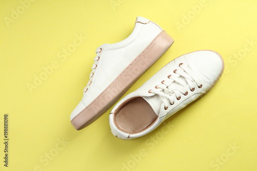 Casual female shoes on color background