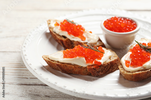 Sandwiches with red caviar on plate