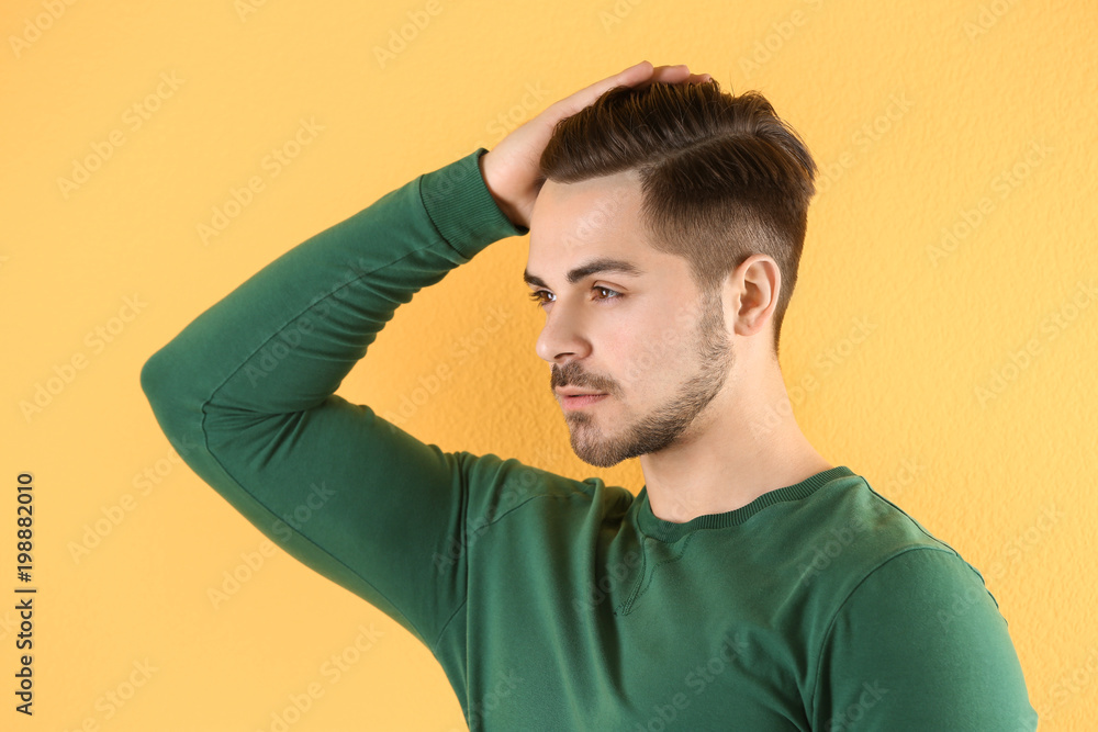 Portrait of young man with beautiful hair on color background Portrait of young man with beautiful hair on color background