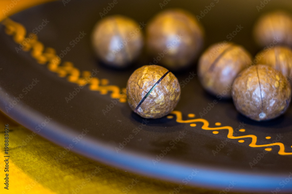 macadamia, Australian nut in a ceramic plate macadamia, Australian nut in a ceramic plate