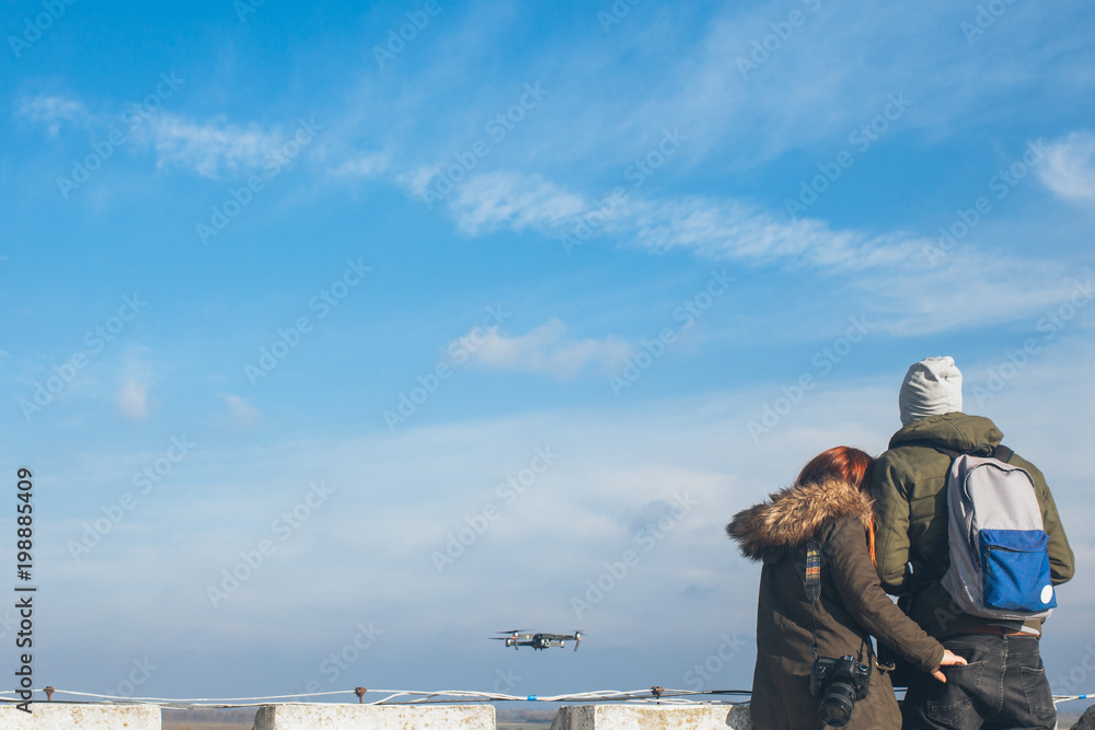 Naklejka premium Two couple taking a selfie with a drone, drone navigating