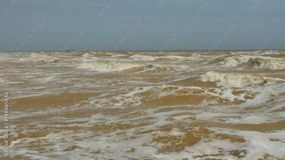a raging yellow water in sea, south wind and sun a raging yellow water in sea, south wind and sun