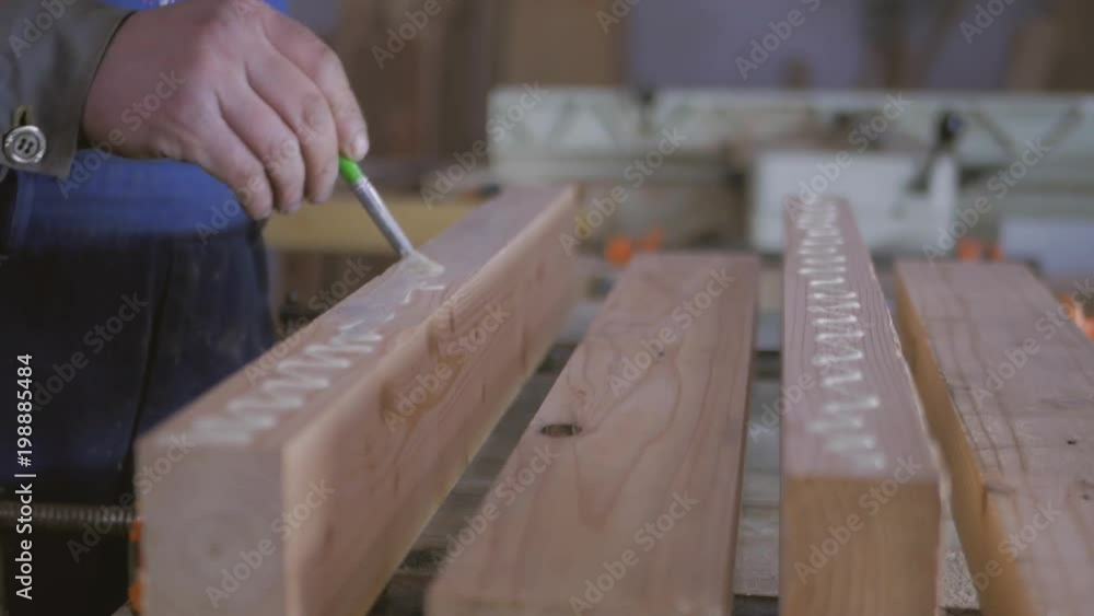 joiner, woodworker, carpenter applies glue to workpieces joiner, woodworker, carpenter applies glue to workpieces