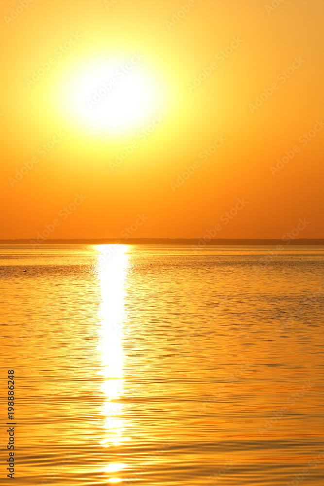 Orange sun over the sea horizon, beautiful sunset, copy space, landscape with a big sun, bloody horizon above the water surface, blank for the designer, orange pattern