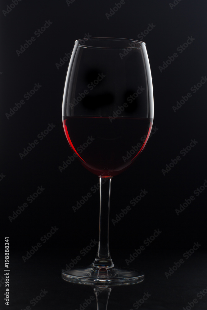 glass of red wine on black background glass of red wine on black background