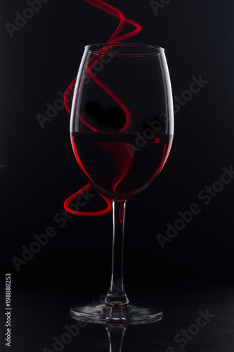red wine on black background with red light