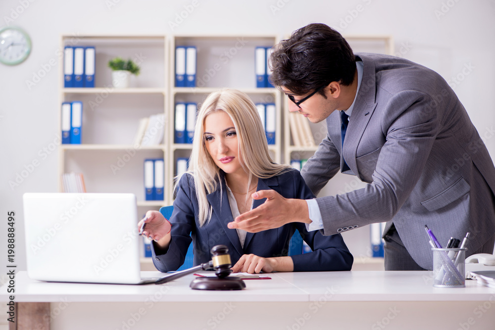 Lawyer discussing legal case with client Lawyer discussing legal case with client