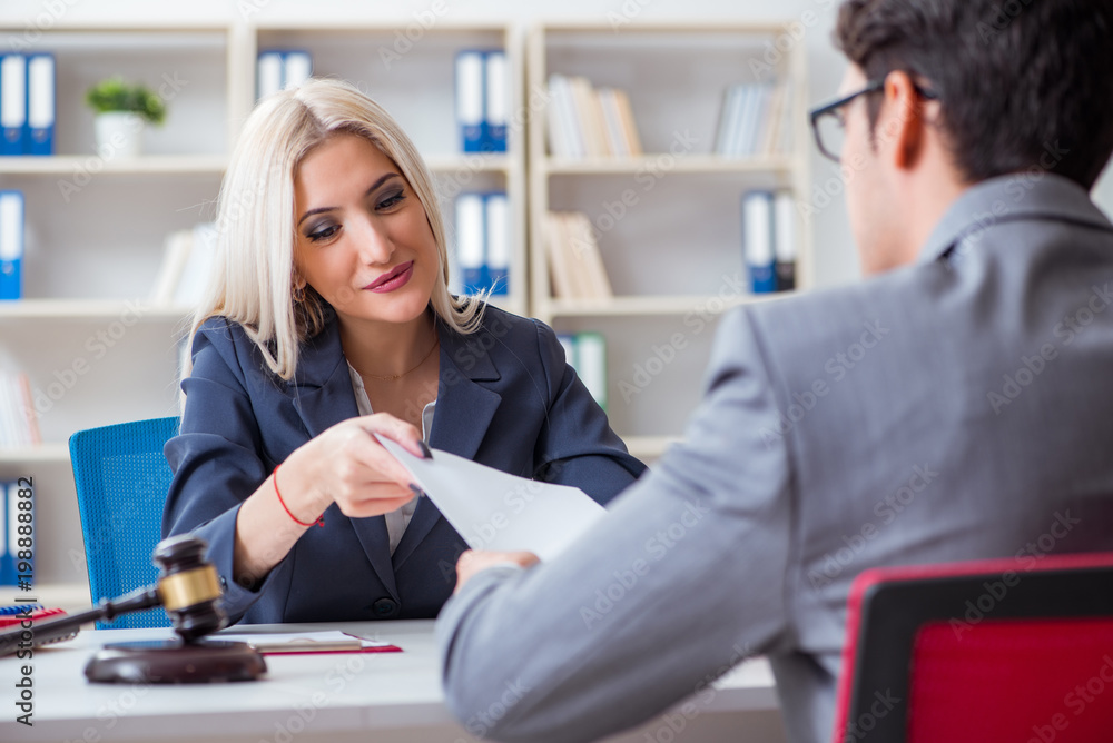 Lawyer discussing legal case with client Lawyer discussing legal case with client